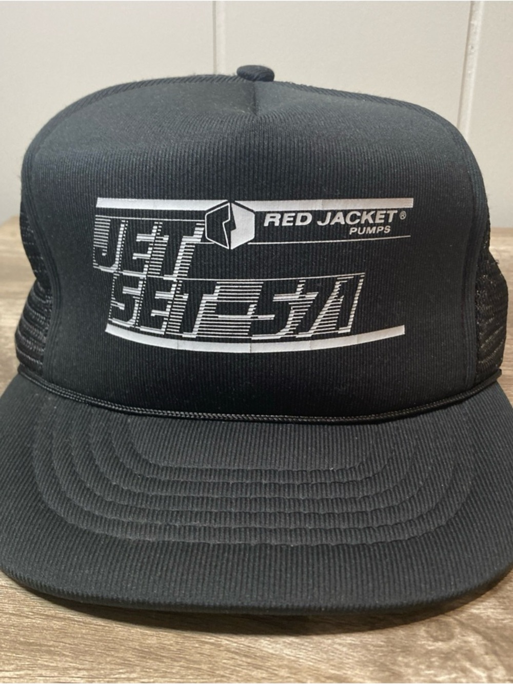 Red Jacket Black Trucker Hat with White Jet Setter Graphics